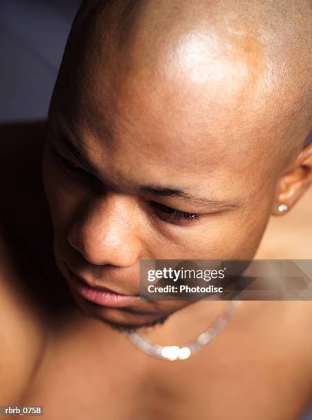 portrait of a young african american man with no shirt as he looks to the side - no stock pictures, royalty-free photos & images