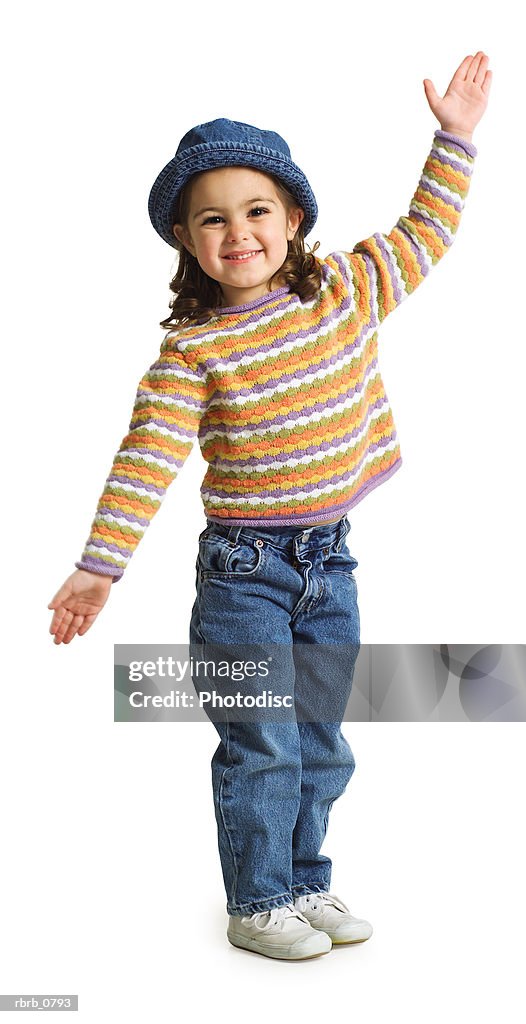 Silhouette of a caucasian female child with a cute hat as she playfully waves to the camera