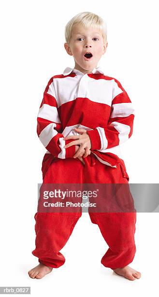 silhouette of a caucasian blonde male child in red pants and a stripped shirt as he leans back and laughs - male dancer blonde stock-fotos und bilder
