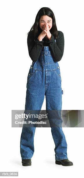 silhouette of an asian teenage girl in denim overalls as she shyly covers her face - olivia wilde co hosts event at birchbox soho in celebration of conscious commerce birchbox collaboration stockfoto's en -beelden