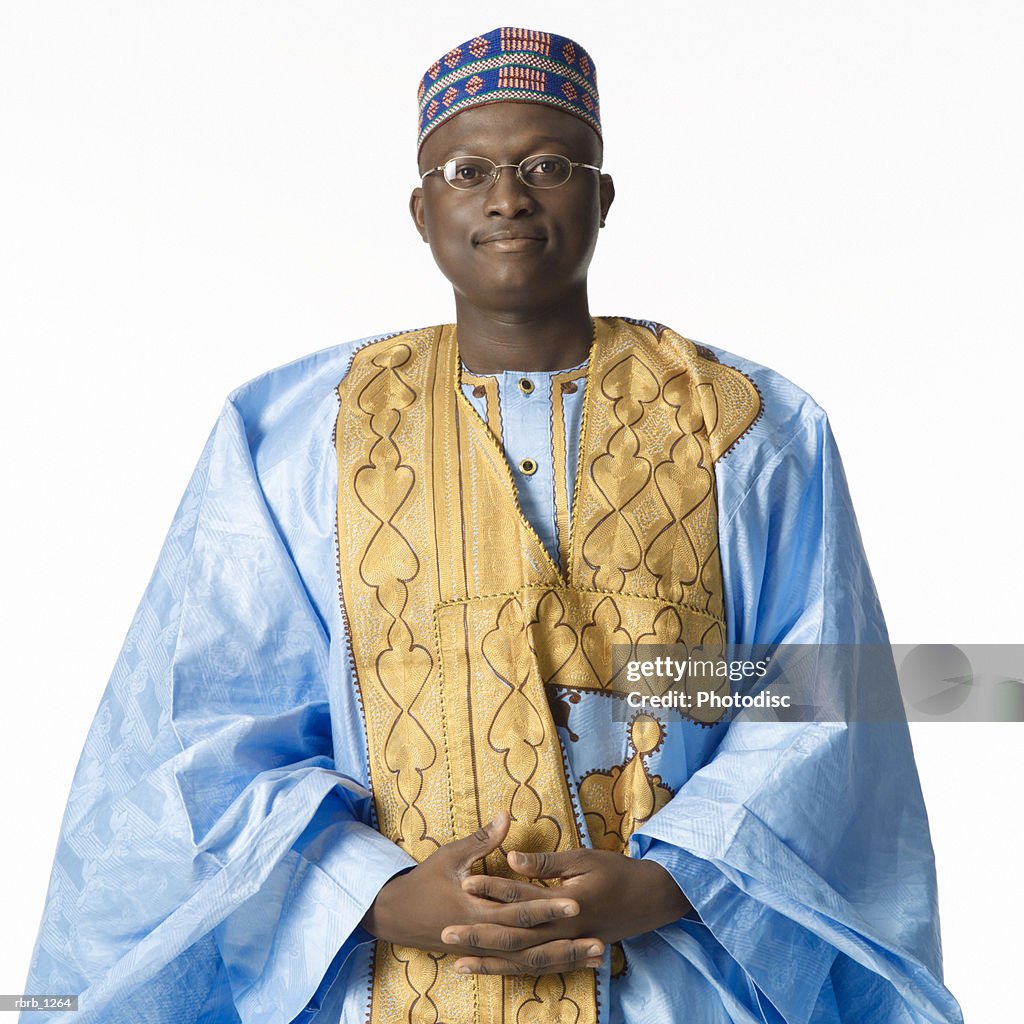 Studio portrait of a young man in traditional african apparel looks seriously into the camera