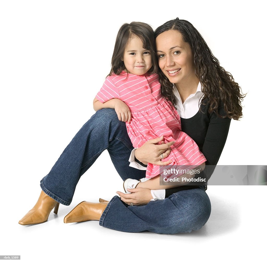 A young ethnic woman sits with her little sister on her lap