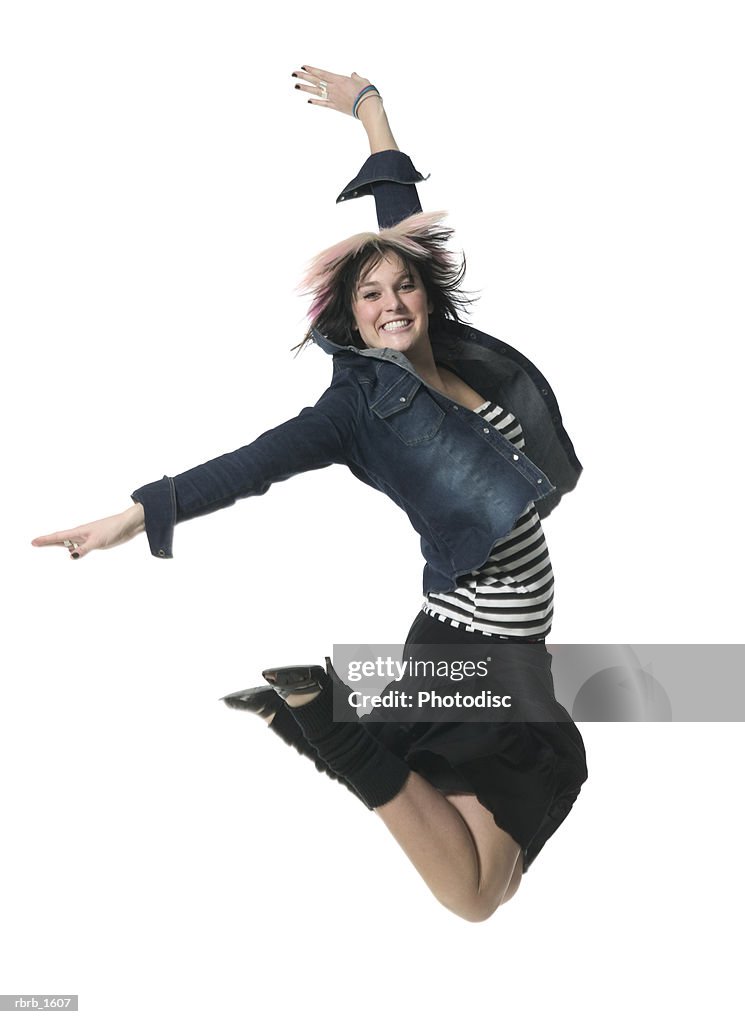 A young caucasian woman in a retro outfit jumps up wildly and smiles