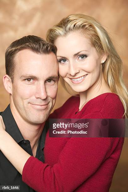 portrait of an attractive caucasian couple as they embrace and smile - smile stock-fotos und bilder