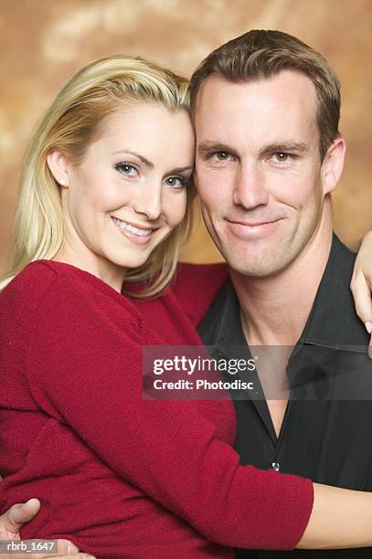 portrait of an attractive caucasian couple as they embrace and smile - smile stock-fotos und bilder