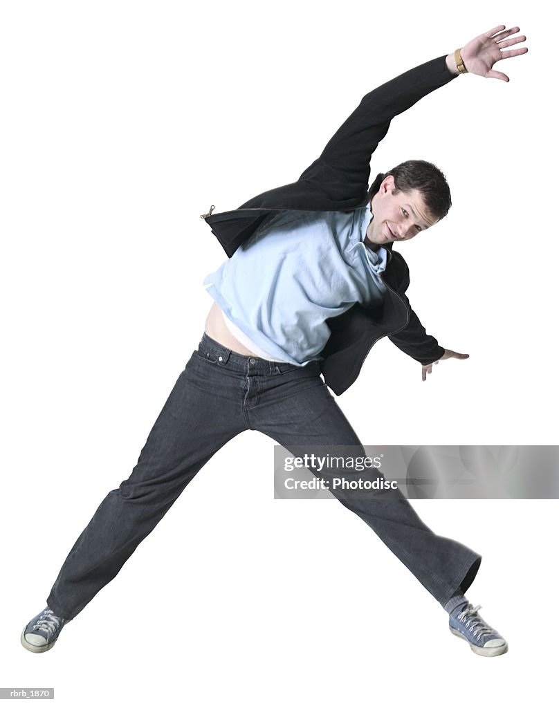 Full body shot of a young adult male in a black jacket as he jumps through the air