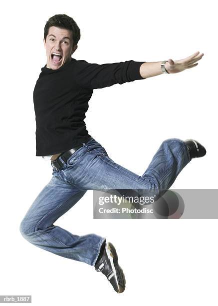 full body shot of a young adult male in a black shirt as he runs and leaps through the air - man full body isolated stock pictures, royalty-free photos & images