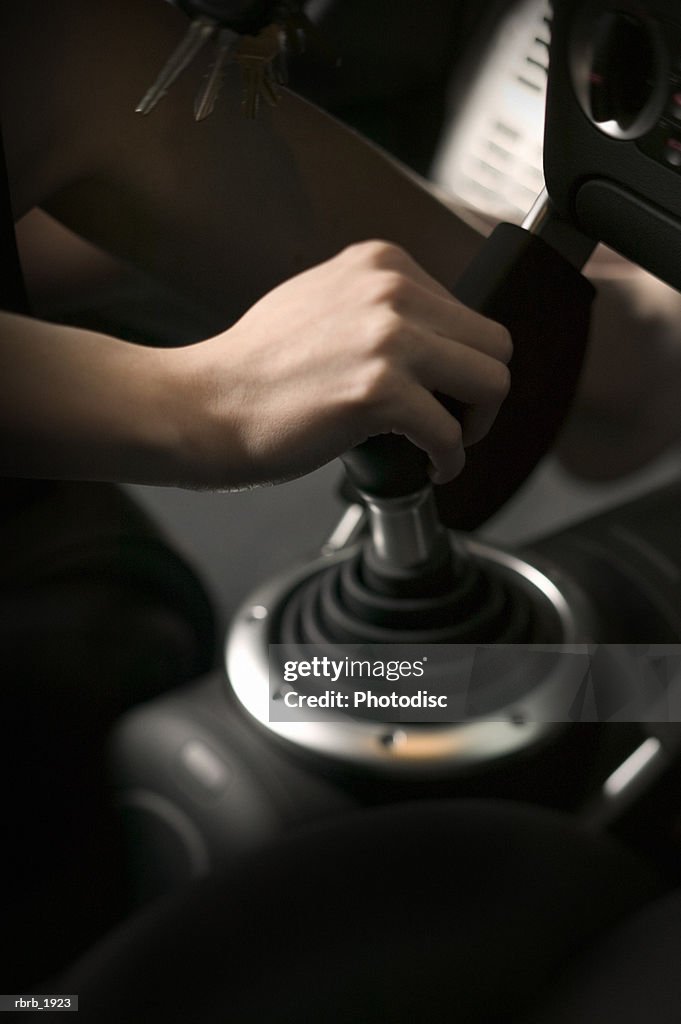 Close up of a hand shifting the gear shift in a sports car
