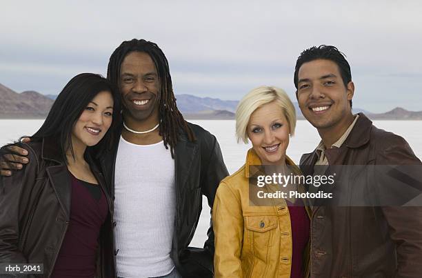 medium shot of a group of four friends as they pose and smile at the utah salt flats - smile bildbanksfoton och bilder