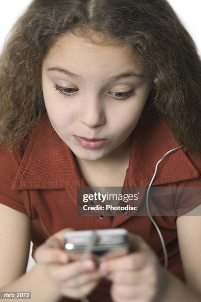 close up shot of a female child as she listens to music on a mp3 player - mp stock pictures, royalty-free photos & images