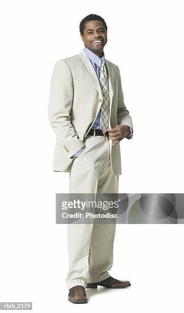 full body shot of a young adult business man in a light suit as he smiles - full suit ストックフォトと画像