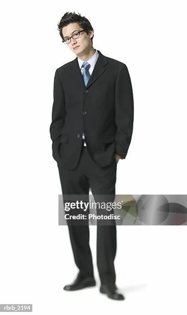 full body shot of a young adult business man in a suit as he puts his hand on his pockets - full hand - fotografias e filmes do acervo