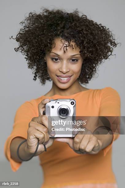 medium shot of a young adult female as she uses her digital camera - uses stock pictures, royalty-free photos & images