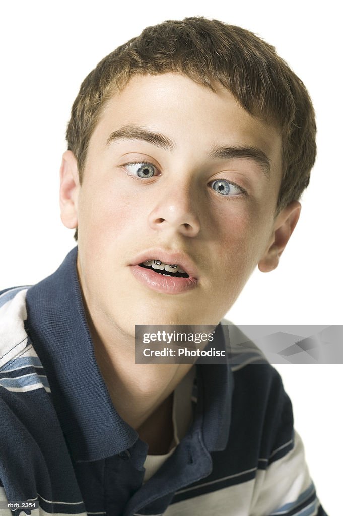Youth portrait of a teenage male in a stripped shirt as he crosses his eyes