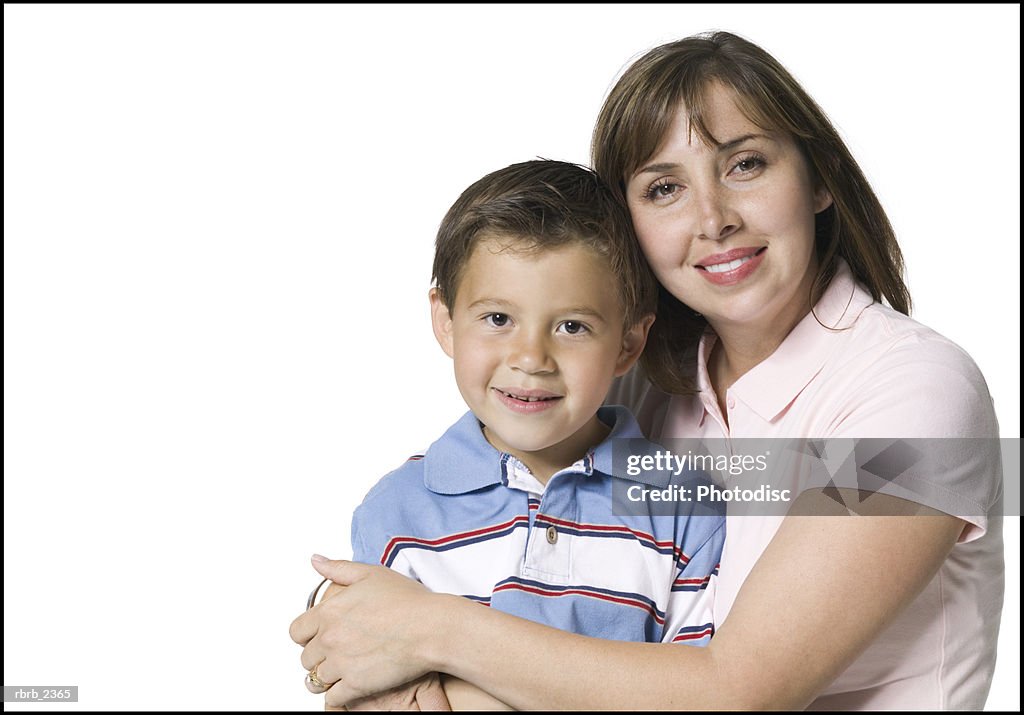 Relationship portrait of an adult mother as she holds and hugs her young son