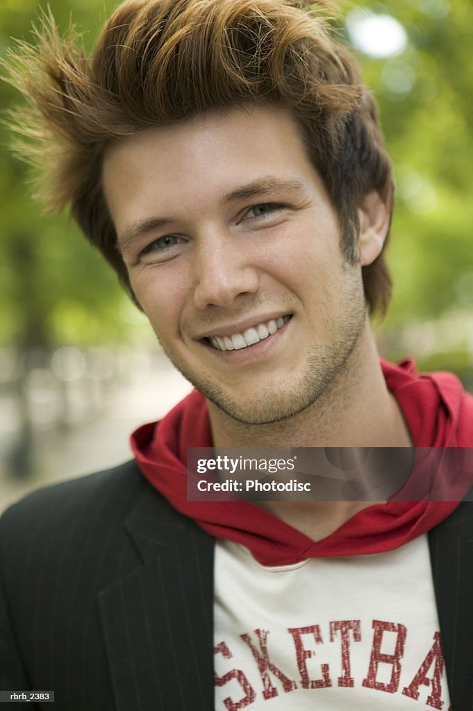 Lifestyle shot of a stylish young adult male as he smiles at the camera