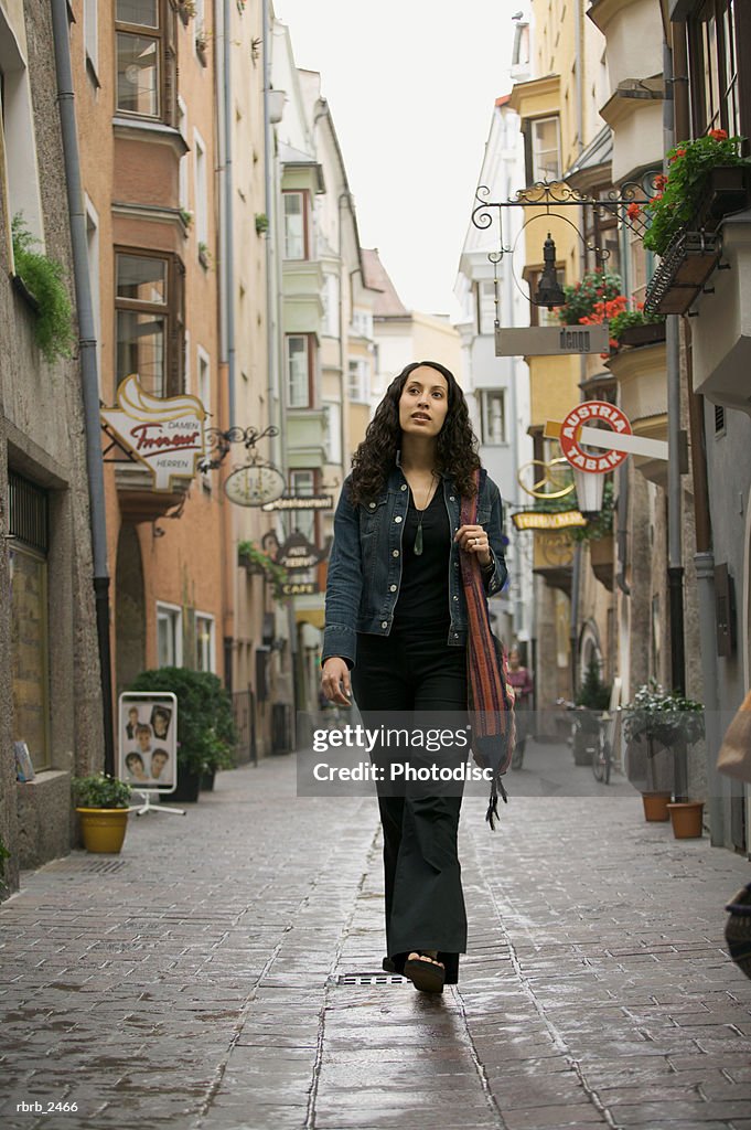 Lifestyle portrait of a young adult woman as she goes sightseeing while visiting europe