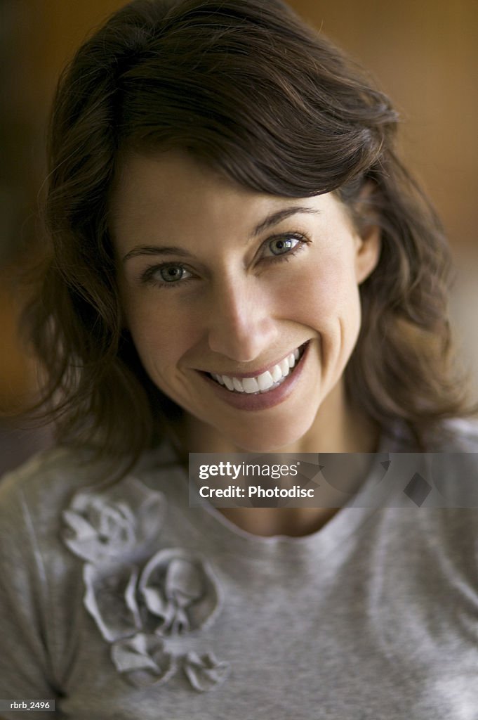 Lifestyle portrait of an adult female brunette as she smiles at the camera