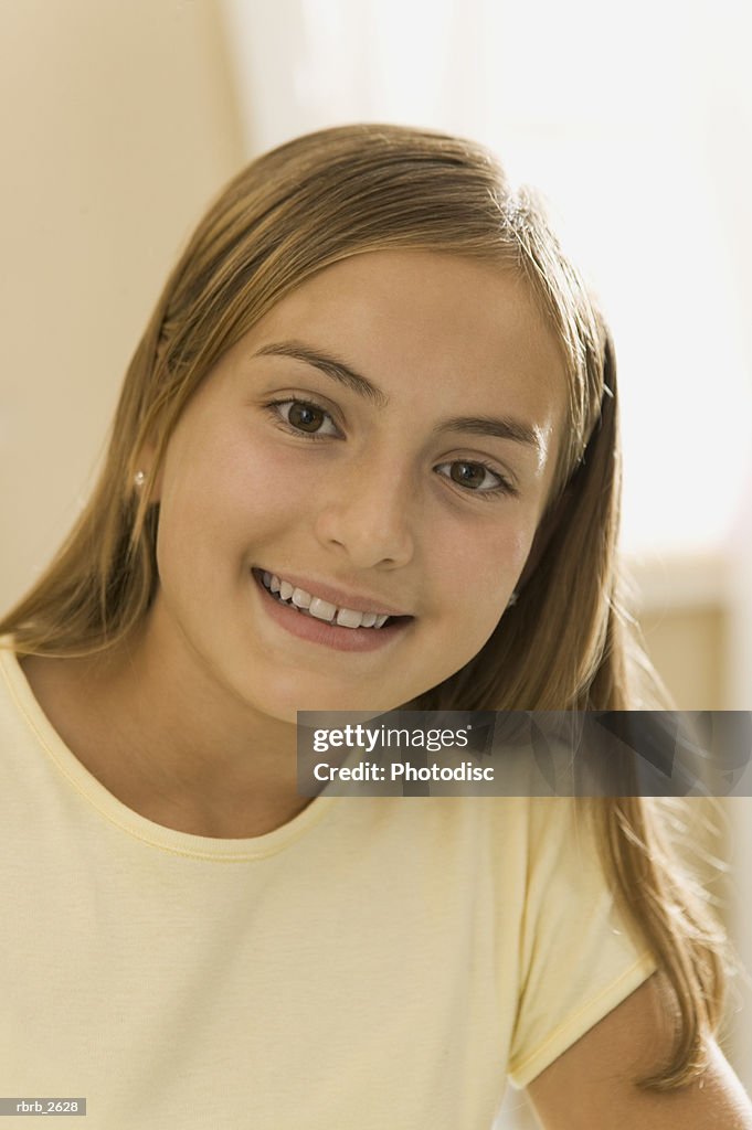 Teenage lifestyle shot of a girl in a yellow shirt as she smiles at the camera