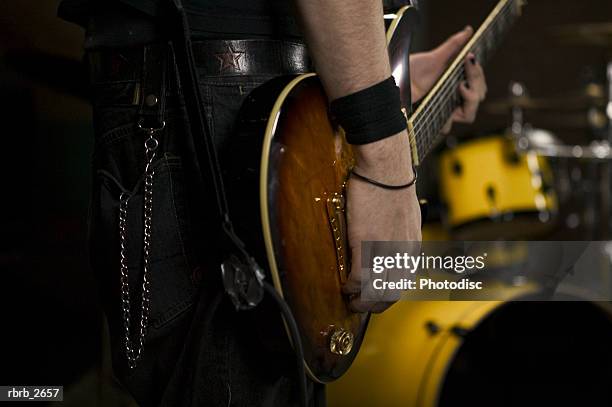 teenage lifestyle shot of a male guitar player as he practices with his garage band - modern rock bildbanksfoton och bilder