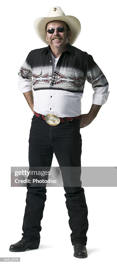 Full length shot of an adult male in a cowboy shirt and hat as he looks at the camera