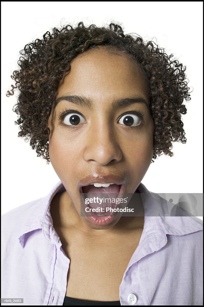 Lifestyle portrait of a teenage female in a purple shirt as she acts surprised