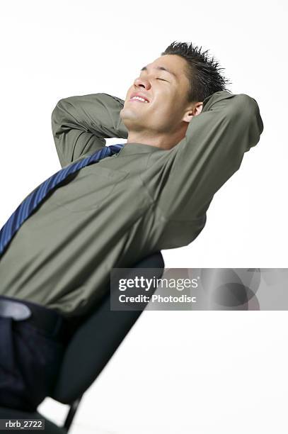 business portrait of an adult male in a green shirt as he leans back in his chair and smiles - back of chair stock pictures, royalty-free photos & images
