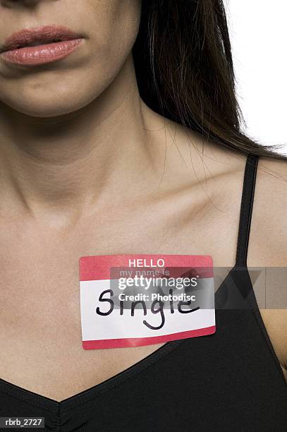 conceptual shot of an adult woman with a name tag that states she is single - tag ストックフォトと画像