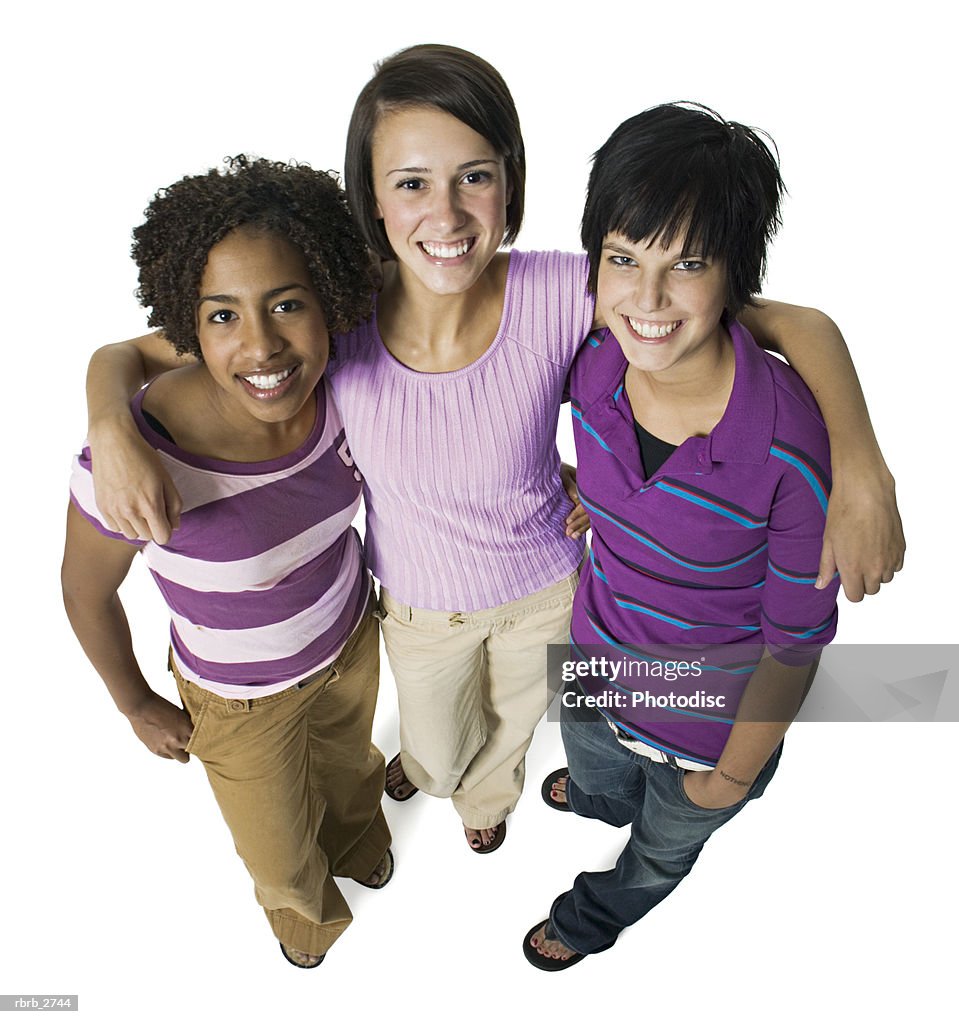 High angle shot of a group of three teenage female friends as they look up and smile