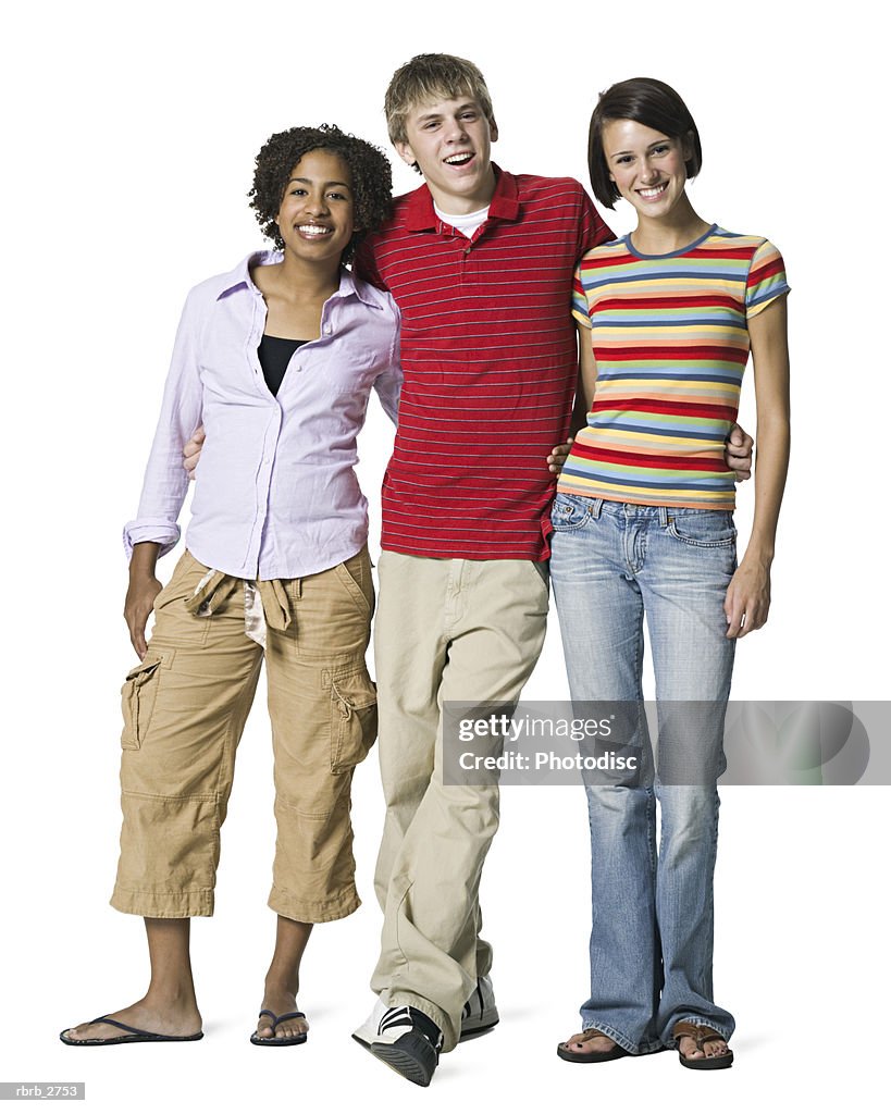 Full length shot of a group of three teenage friends as they smile at the camera