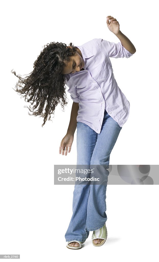 Full length shot of a teenage female as she playfully dances and tosses her hair around