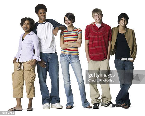 full length shot of a group of five teenage friends as they smile at the camera - smile stock-fotos und bilder