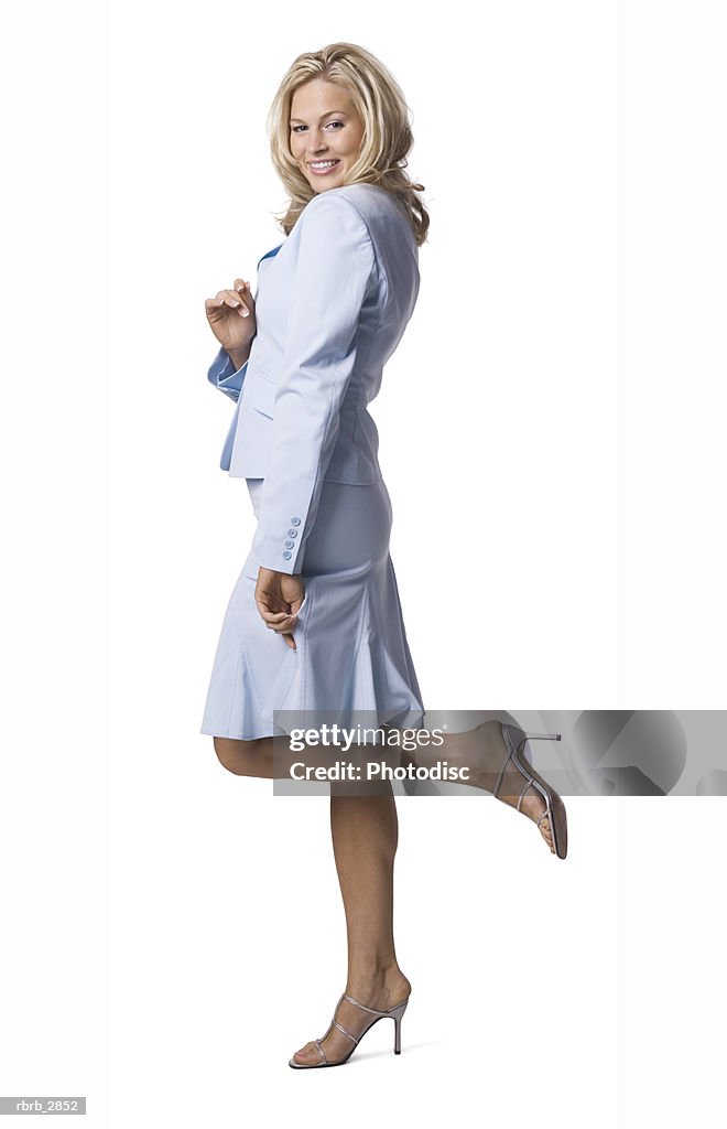 Side profile of a young woman standing with a leg raised