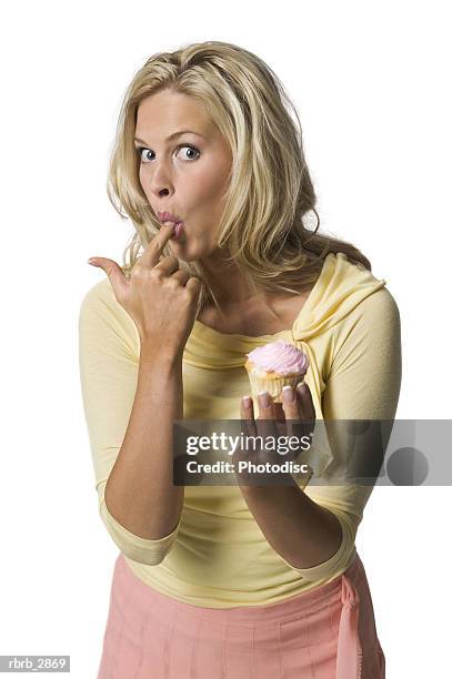 portrait of a young woman licking icing off her finger - taste of john paul ataker presentation spring 2016 new york fashion week stockfoto's en -beelden