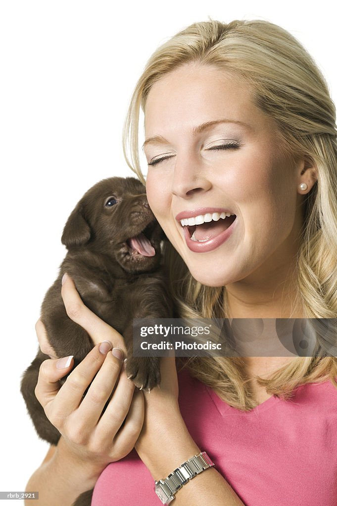 Close-up of a young woman holding a puppy