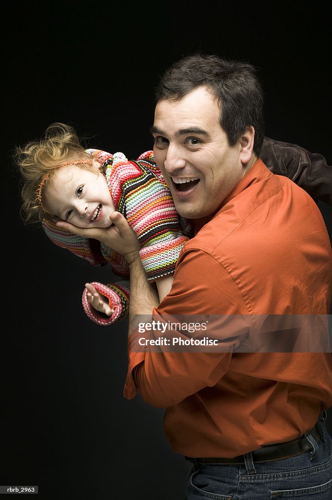 Portrait of a father playing with his daughter