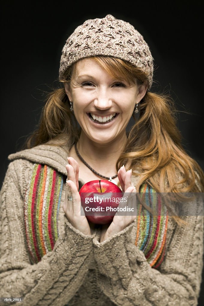 Portrait of a woman holding an apple