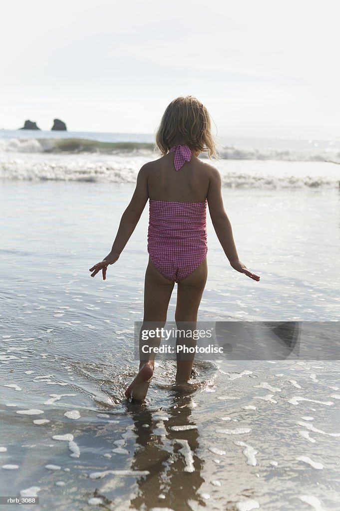 Rear view of a girl standing on the beach