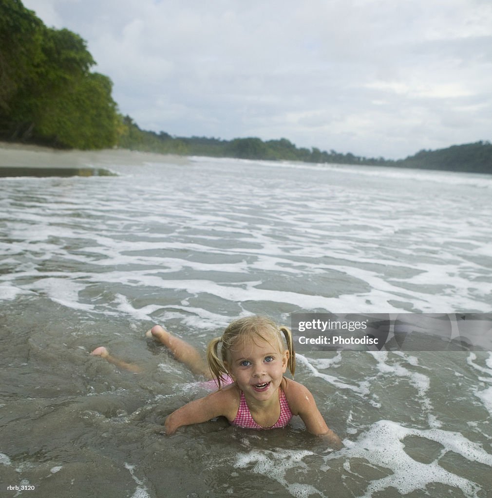 Portrait of a girl lying in water at the beach