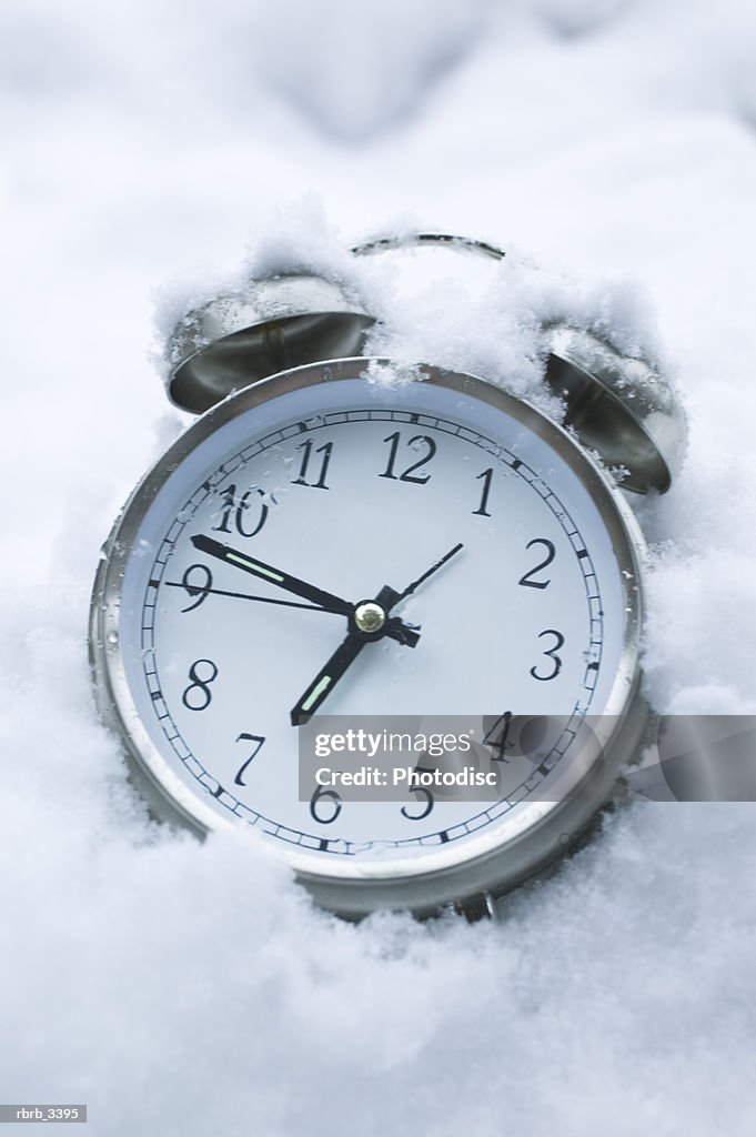 Close-up of a alarm clock in the snow
