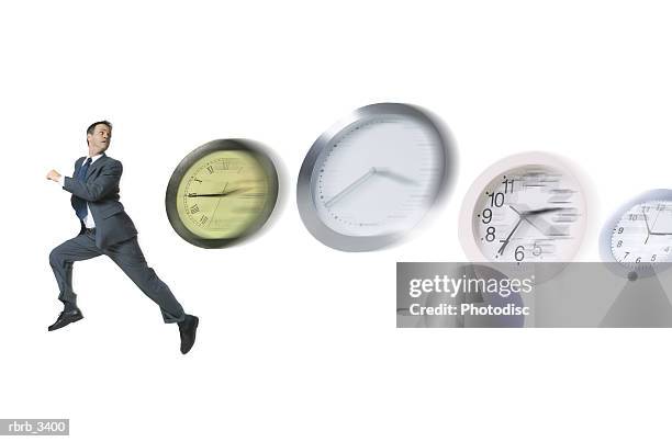 man running with clocks chasing him - hour hand stock pictures, royalty-free photos & images