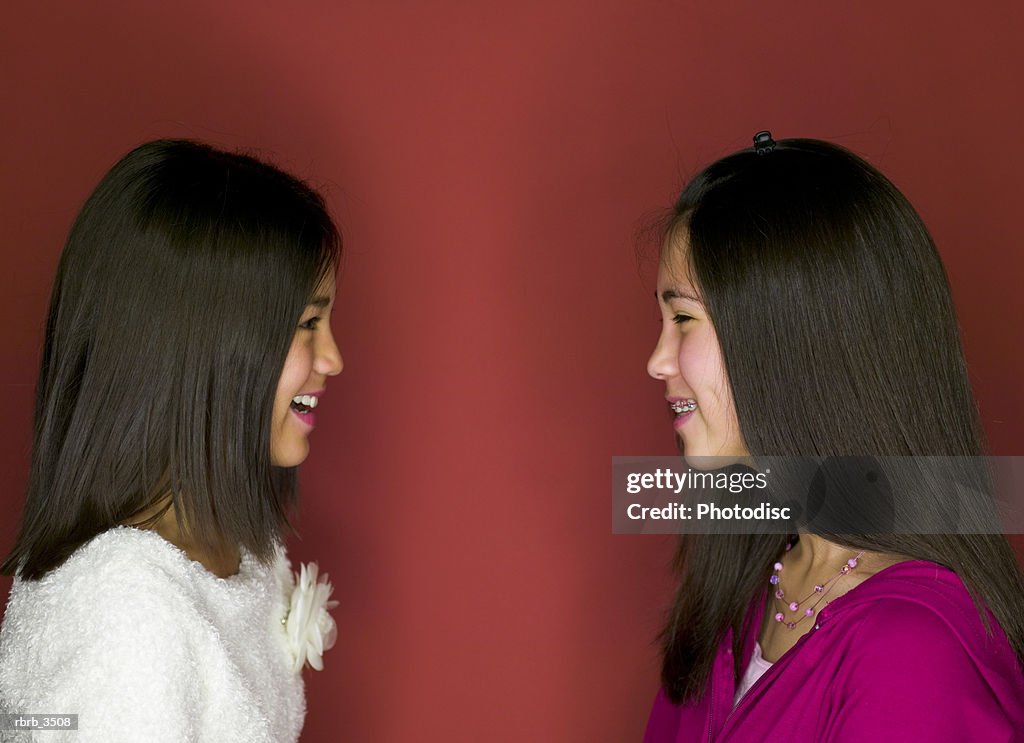 Two girls (8-9) looking at each other