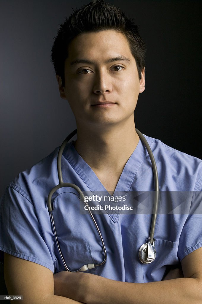 Portrait of a surgeon standing with arms crossed