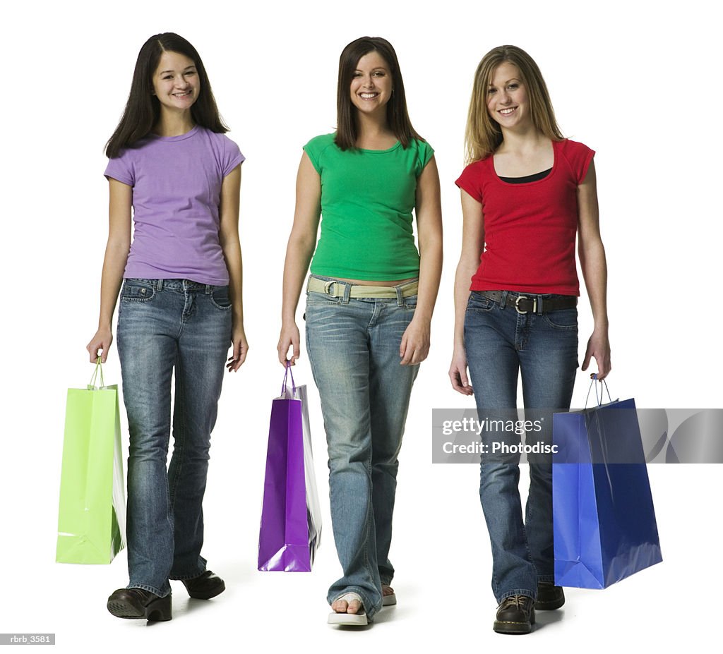 Portrait of teenage girls carrying shopping bags