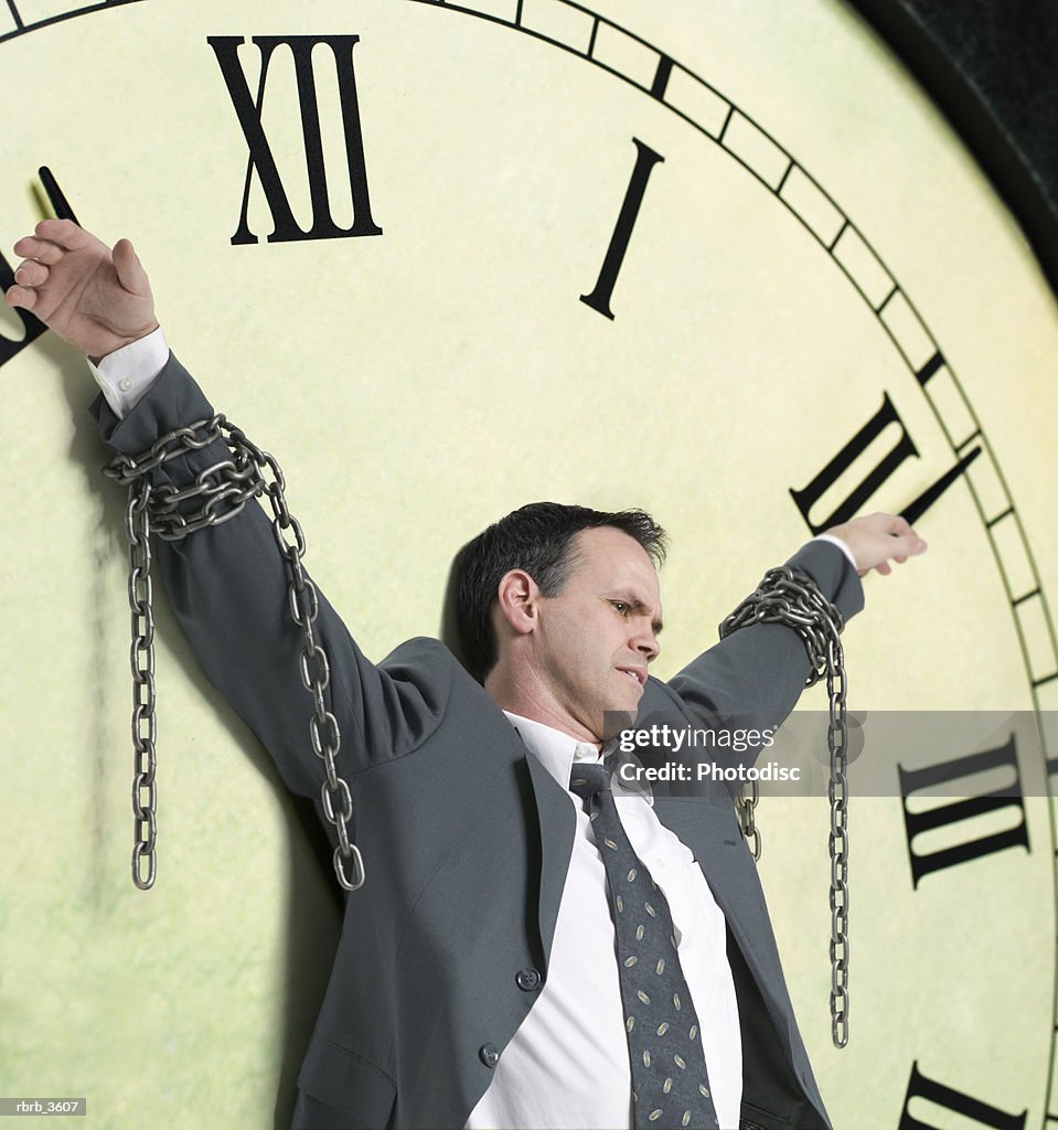 Mature man tied to a clock