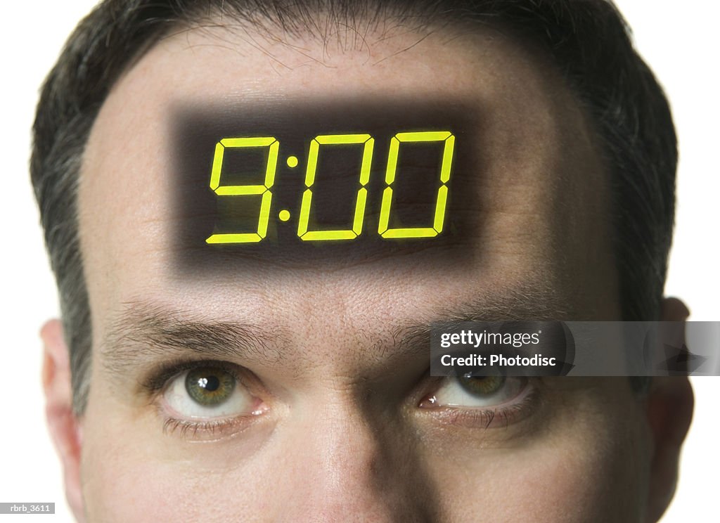 Close-up of a man with a digital clock on his forehead