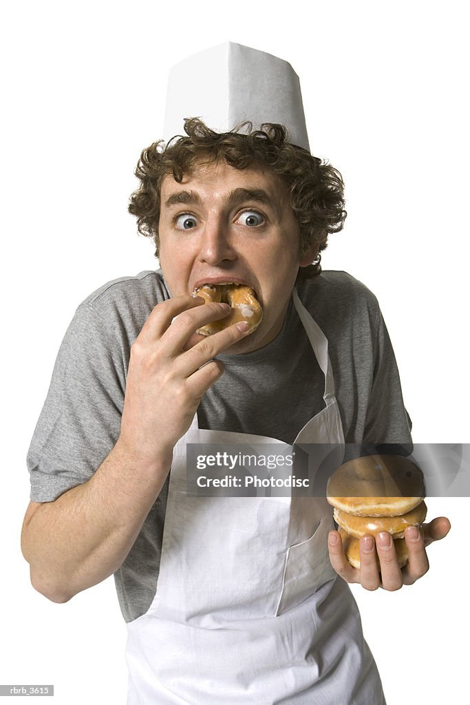Portrait of a young man eating a bun