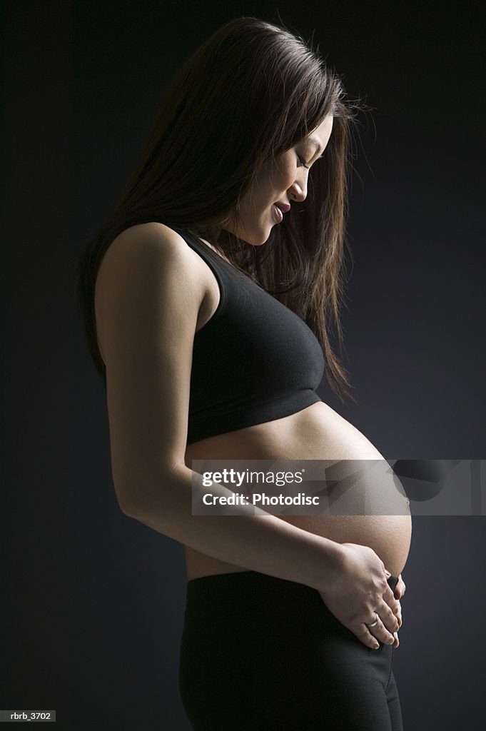 Side profile of a young pregnant woman