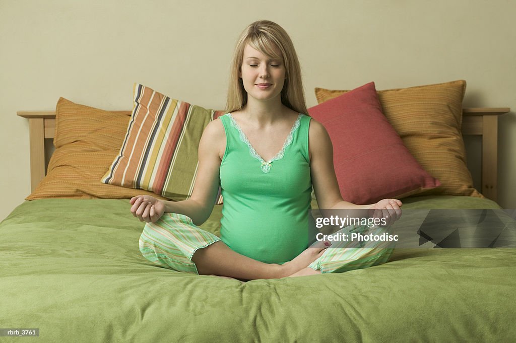 Young pregnant woman in the lotus position