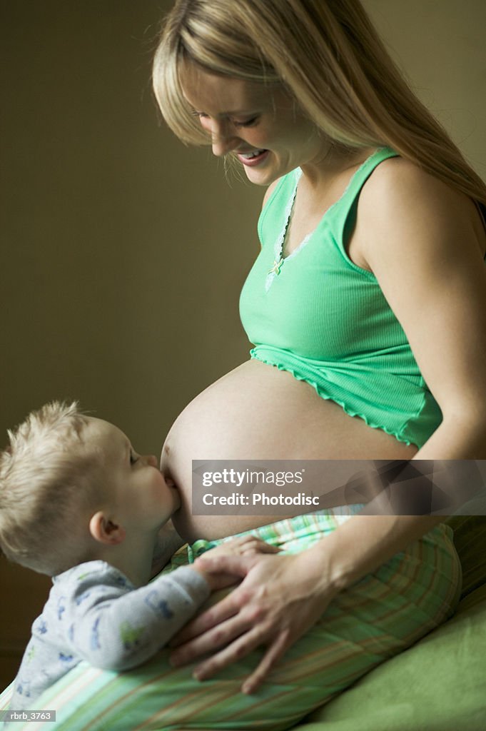 Side profile of a young pregnant women with her child